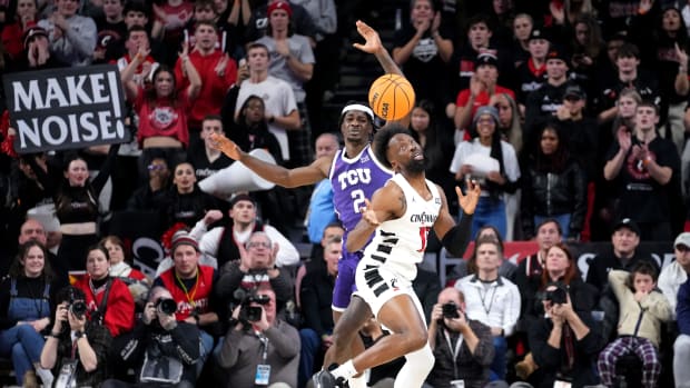 Cincinnati Bearcats forward John Newman III (15) steals the ball from TCU Horned Frogs forward Emanuel Miller (2) in the overtime period of a college basketball game between the TCU Horned Frogs and the Cincinnati Bearcats, Tuesday, Jan. 16, 2024, at Fifth Third Arena in Cincinnati. The Cincinnati Bearcats won, 81-77.
